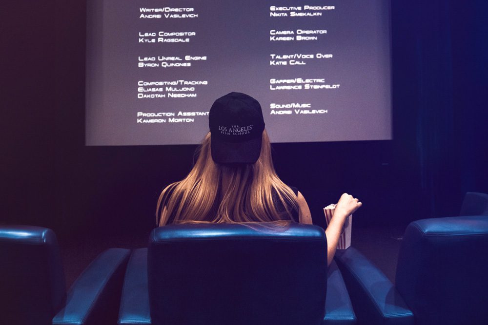 Woman with Hat watching movie credits