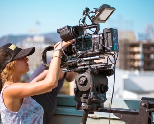 Woman Looking through Camera over Hollywood