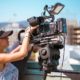 Woman Looking through Camera over Hollywood