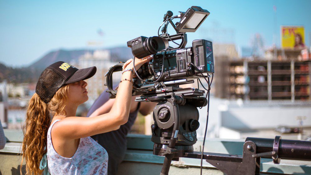 Woman Looking through Camera over Hollywood