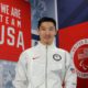 image of YanXiao Gong in front of a banner reading "We Are Team USA"