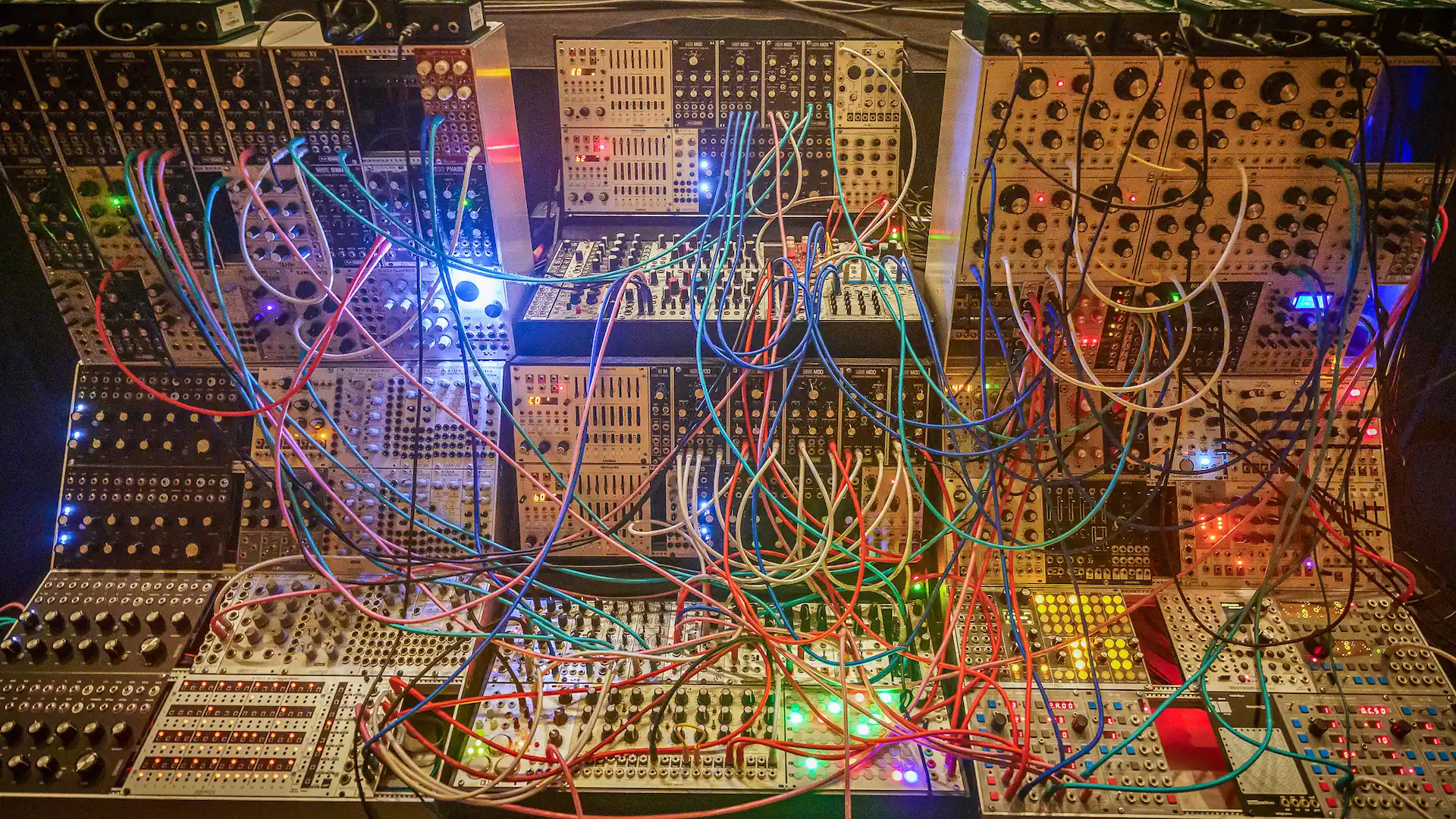 tangled wires all over a modular synth; women in electronic music